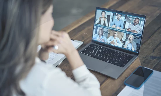 Financial consultant holds a video conference with her team via Microsoft Teams.