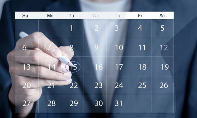 Hand marking a date on a digital calendar – Preview of upcoming events and webinars